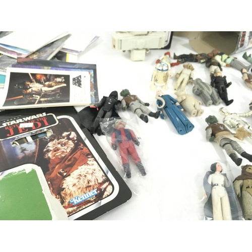 122 - A collection of vintage STAR WARS figures . Also includes accessories ..post cards..weapons and back... 