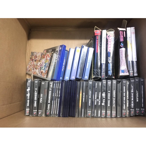 124 - A box containing various video games and consoles includes PSP..Sega..Nintendo. Some game boxes are ... 