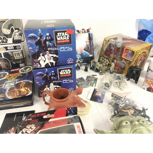 126 - A collection of modern Star Wars toys..books..figures etc.