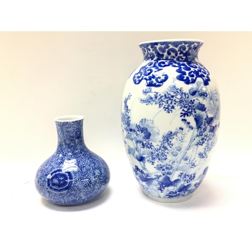 1003 - Chinese blue and white vases with floral decoration, one with restoration. 11 and 22cm tall. Postage... 