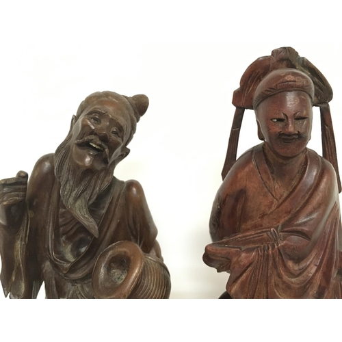 1013 - 19th century wooden carvings of oriental figures. 25cm tall approximately. Postage category C