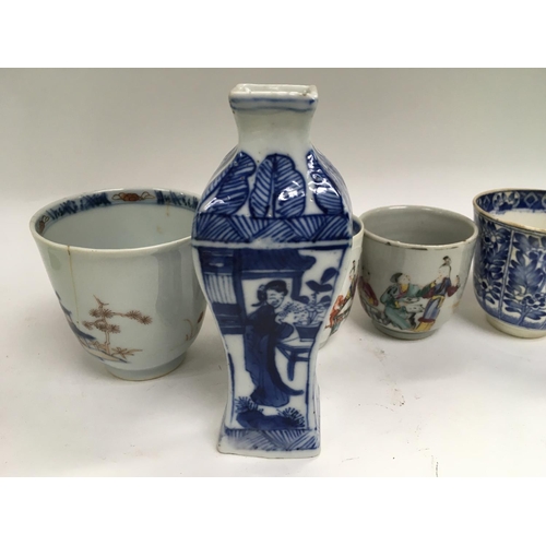 1017 - A collection of Chinese ceramics including a small blue and white vase13 cm four cups and a dish .