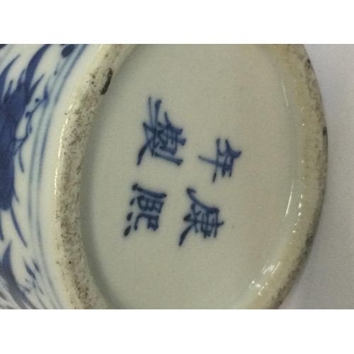 1023 - A Chinese blue and white vase decorated with birds figures and foliage.four marks to base 20cm .