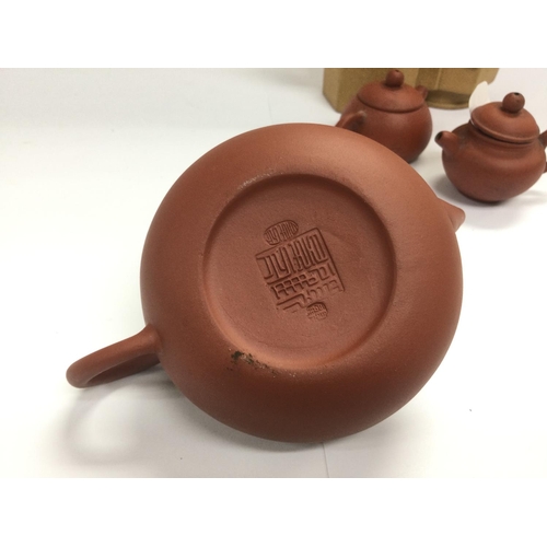 1036 - Four small terracotta teapots, tallest approx 12cm. Shipping category D.