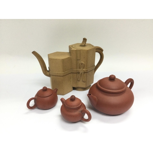 1036 - Four small terracotta teapots, tallest approx 12cm. Shipping category D.