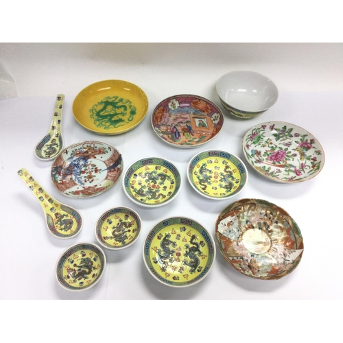 1040 - A collection of Oriental dishes and spoons. Shipping category D.