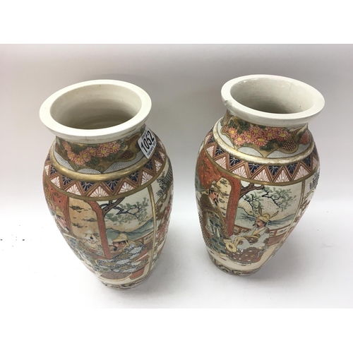 1052 - A pair of Japanese satsuma vases decorated with figures and landscapes. 30cm x 15cm.