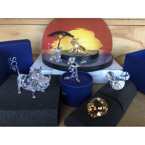 1113 - A collection of Swarovski Disney Characters from The Lion King, together with a golden lion. Togethe... 