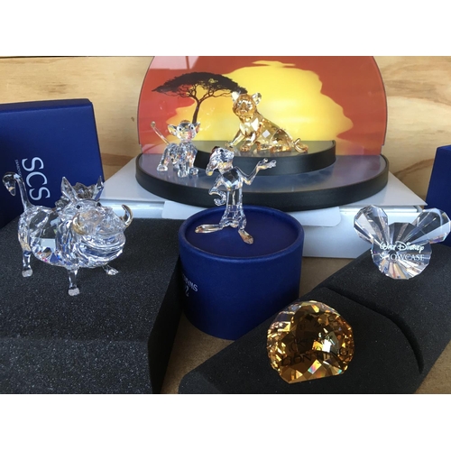 1113 - A collection of Swarovski Disney Characters from The Lion King, together with a golden lion. Togethe... 