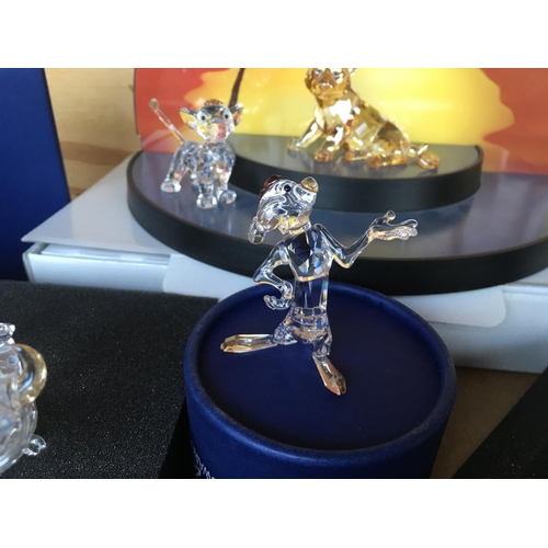 1113 - A collection of Swarovski Disney Characters from The Lion King, together with a golden lion. Togethe... 