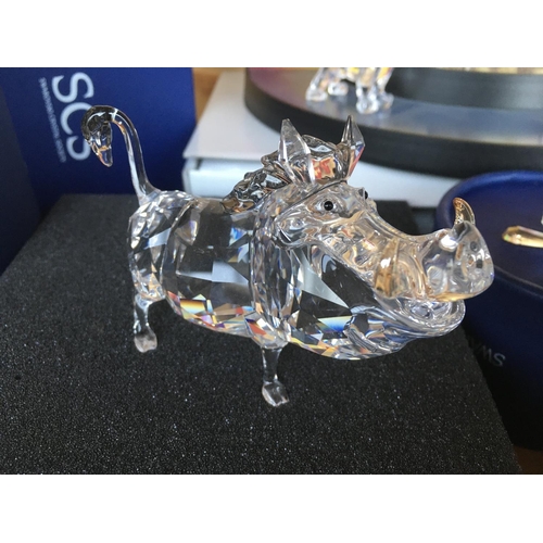 1113 - A collection of Swarovski Disney Characters from The Lion King, together with a golden lion. Togethe... 