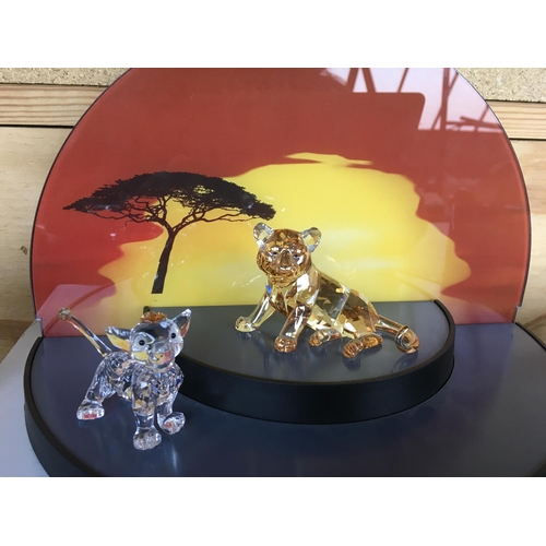 1113 - A collection of Swarovski Disney Characters from The Lion King, together with a golden lion. Togethe... 