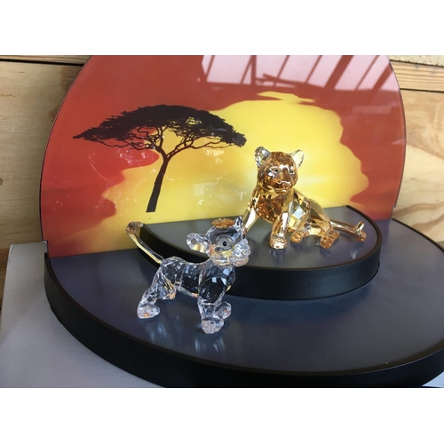 1113 - A collection of Swarovski Disney Characters from The Lion King, together with a golden lion. Togethe... 