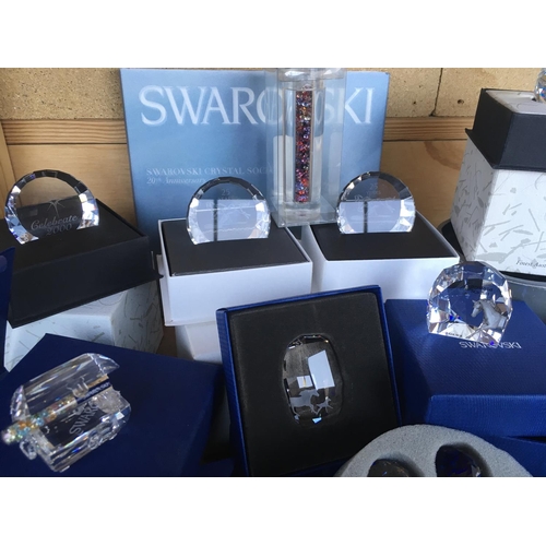 1114 - A box containing a collection of Swarovski commemorative plaques and paperweights- including Disney,... 