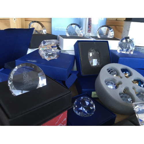 1114 - A box containing a collection of Swarovski commemorative plaques and paperweights- including Disney,... 