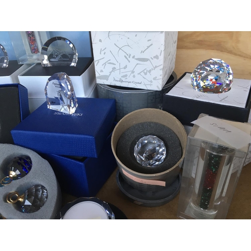 1114 - A box containing a collection of Swarovski commemorative plaques and paperweights- including Disney,... 