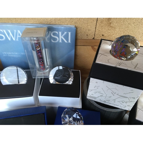 1114 - A box containing a collection of Swarovski commemorative plaques and paperweights- including Disney,... 