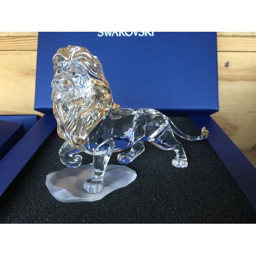 1120 - Three boxed Swarovski items including Male Lion Figure on Rock, Lion cub Figure and an Endangered Wi... 