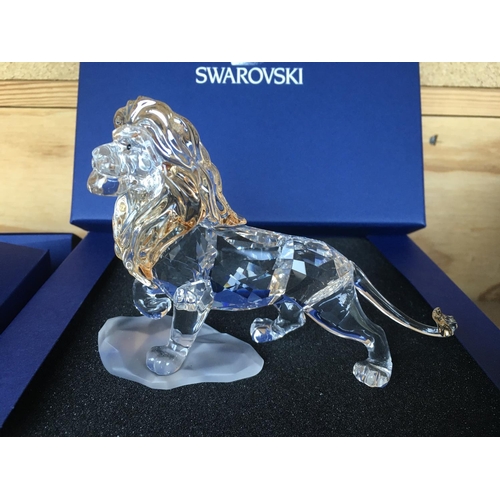 1120 - Three boxed Swarovski items including Male Lion Figure on Rock, Lion cub Figure and an Endangered Wi... 