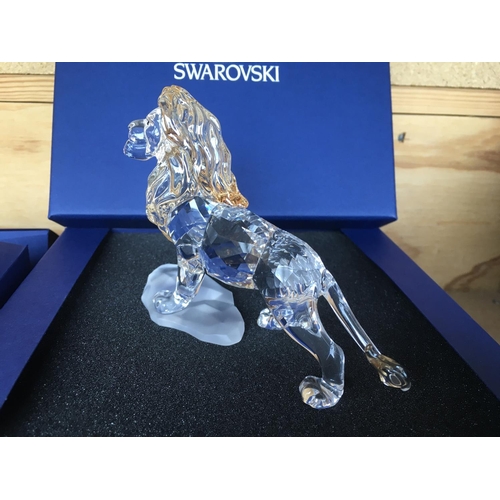 1120 - Three boxed Swarovski items including Male Lion Figure on Rock, Lion cub Figure and an Endangered Wi... 