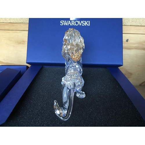 1120 - Three boxed Swarovski items including Male Lion Figure on Rock, Lion cub Figure and an Endangered Wi... 