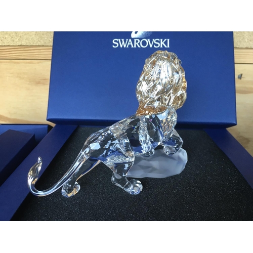 1120 - Three boxed Swarovski items including Male Lion Figure on Rock, Lion cub Figure and an Endangered Wi... 