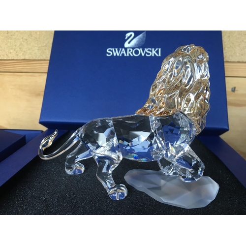 1120 - Three boxed Swarovski items including Male Lion Figure on Rock, Lion cub Figure and an Endangered Wi... 