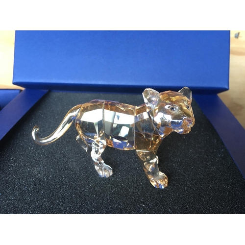 1120 - Three boxed Swarovski items including Male Lion Figure on Rock, Lion cub Figure and an Endangered Wi... 