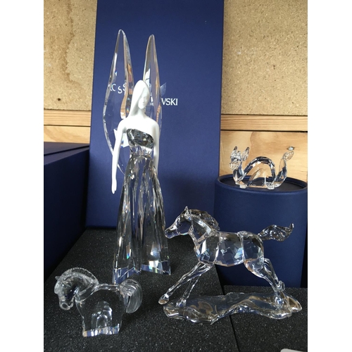 1127 - Four boxed Swarovski figures including standing Fairy, dragon and two horses with certificate of aut... 