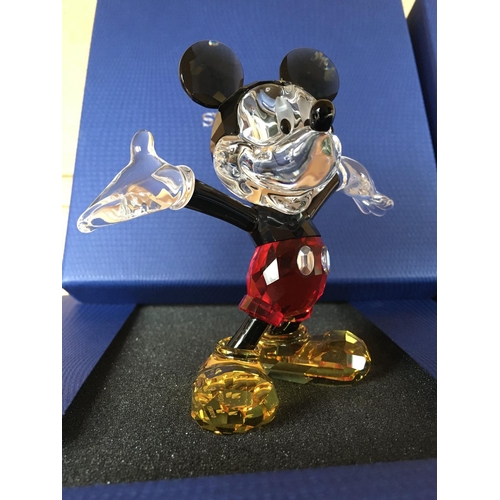 1134 - Three boxed Disney figures including large versions of Minnie and Mickey Mouse in classic Disney col... 