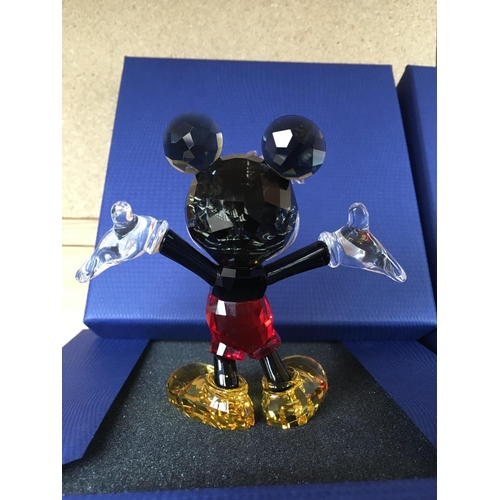 1134 - Three boxed Disney figures including large versions of Minnie and Mickey Mouse in classic Disney col... 