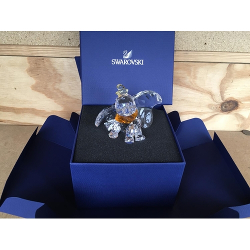 1136 - A boxed Swarovski figure of Disneyâs Dumbo the elephant 2011, with yellow hat and orange necktie. ... 