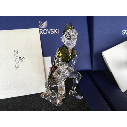 1137 - Three boxed Disney Swarovski items including Pinocchio, Peter Pan in green costume figure and crysta... 