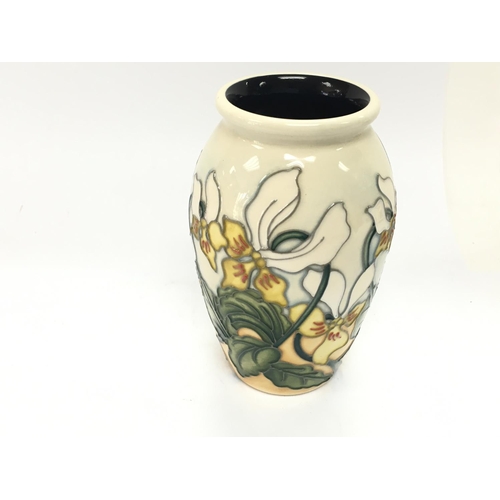 1209 - A small Moorcroft vase ref 2 SEAP393/4. Good condition 11cm tall.