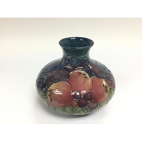 1214 - WITHDRAWN -A Moorcroft onion vase depicting birds and fruit on a green and blue ground, approx heigh... 