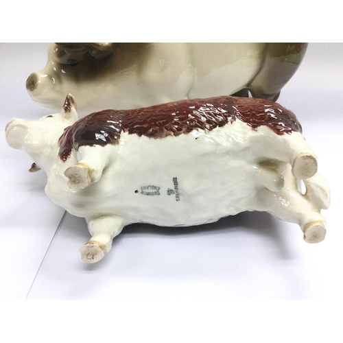 1294 - A Beswick figure of a Herefordshire bull and a ceramic piggy bank (2). Shipping category D.