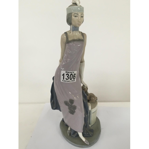 1306 - A large Lladro figure of a lady in Art Deco design dress with a dog seated on a pedestal no obvious ... 