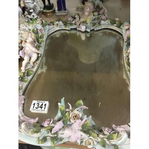 1341 - A German porcelain mirror with cherubs and flowers. 20cm