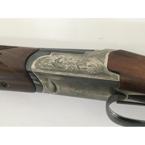 1667 - A 12 bore shotgun over and under barrels 27.5 inch barrels with interchangeable multi choke stock le... 