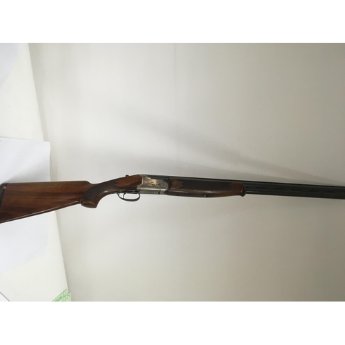 1667 - A 12 bore shotgun over and under barrels 27.5 inch barrels with interchangeable multi choke stock le... 