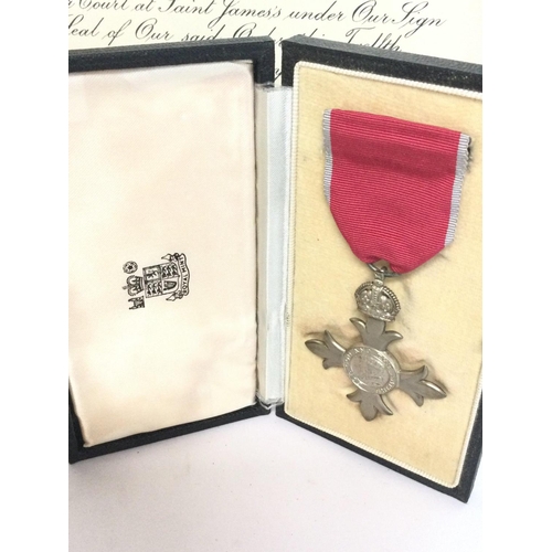 1671 - A cased MBE award medal and paperwork. Postage category C