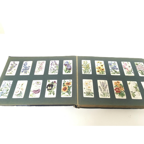 1809 - A collection of various cigarette card albums including Players, Wills etc.