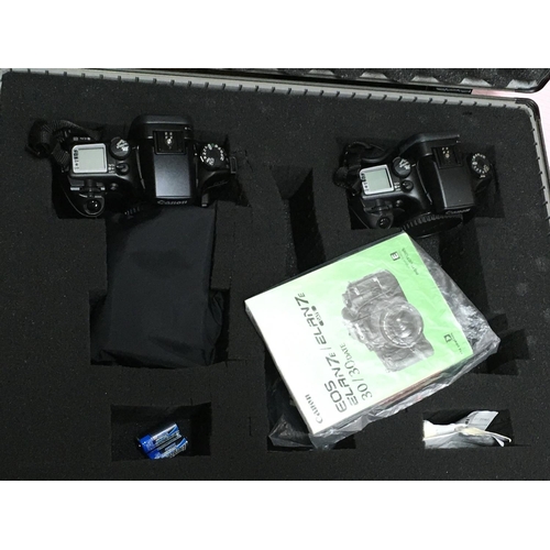 1923 - Two EOS 30 cameras in a fitted case without lens , postage category C