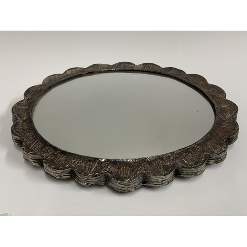 973 - An eastern white metal (tested Silver) overlaid mirror. (D) 21cm x 16.5cm.