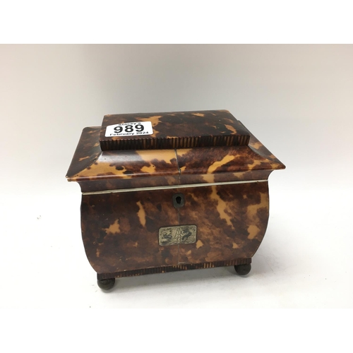 989 - A tortoiseshell tea caddy with hinge lid enclosing 2 compartments. On brass circler feet. 15cm x 16c... 