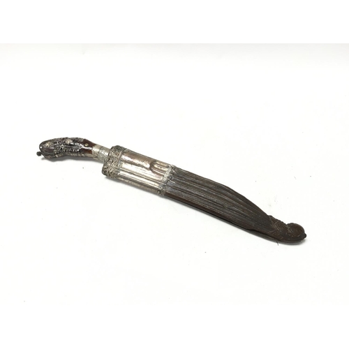 992 - A unusual white metal and carved wood dagger, possibly 18th century with a shape and decorative grip... 