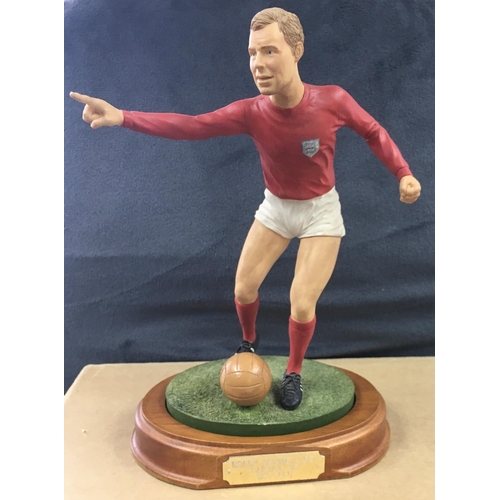 70 - Bobby Moore1966 England World Cup Football Figure: 9 inch high figure in red England kit on original... 