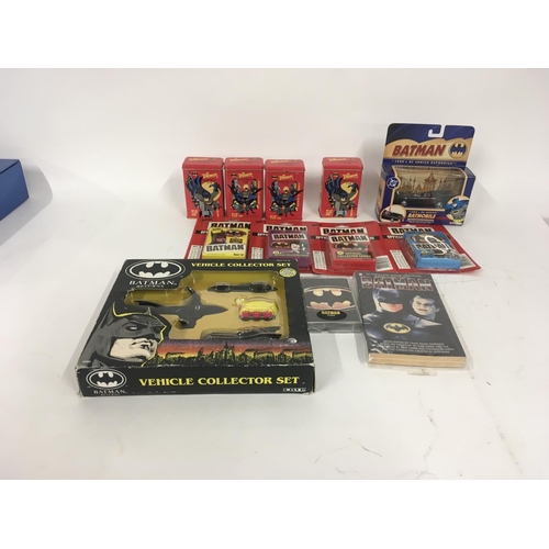 693 - A collection of Batman related items including diecast vehiclescollectors cards..surprise tins etc.... 