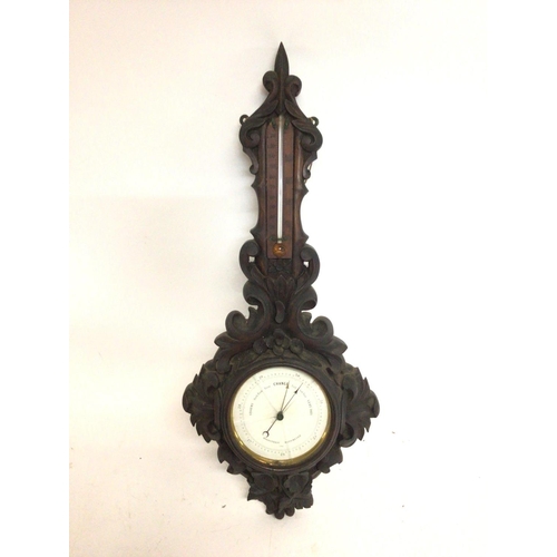 1310 - A carved wooden barometer. 58cm tall. This lot cannot be posted