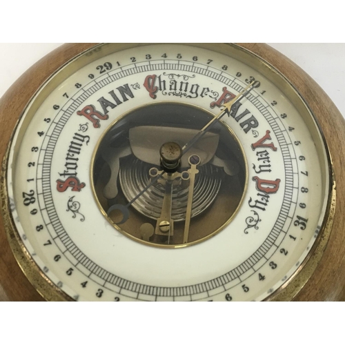 1313 - A silvered dial round wall barometer and an anroid barometer with visible mechanism, diameters of 26... 